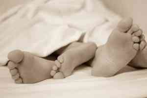 Feet of a Couple on Bed