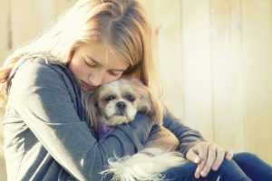 Girl hugging a dog