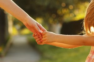 Little girl holding an adult's hand