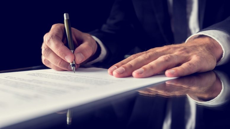 a lawyer signing a legal document