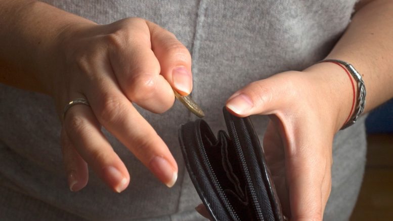 Woman putting a coin in her purse