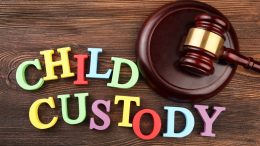 A gavel beside colorful letters spelling out CHILD CUSTODY